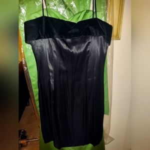 Junior size 11/12 short black form fitting cocktail dress. Black satin appearanc